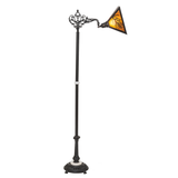 Side lit view highlighting pine needle cutout on rustic lamp shade.