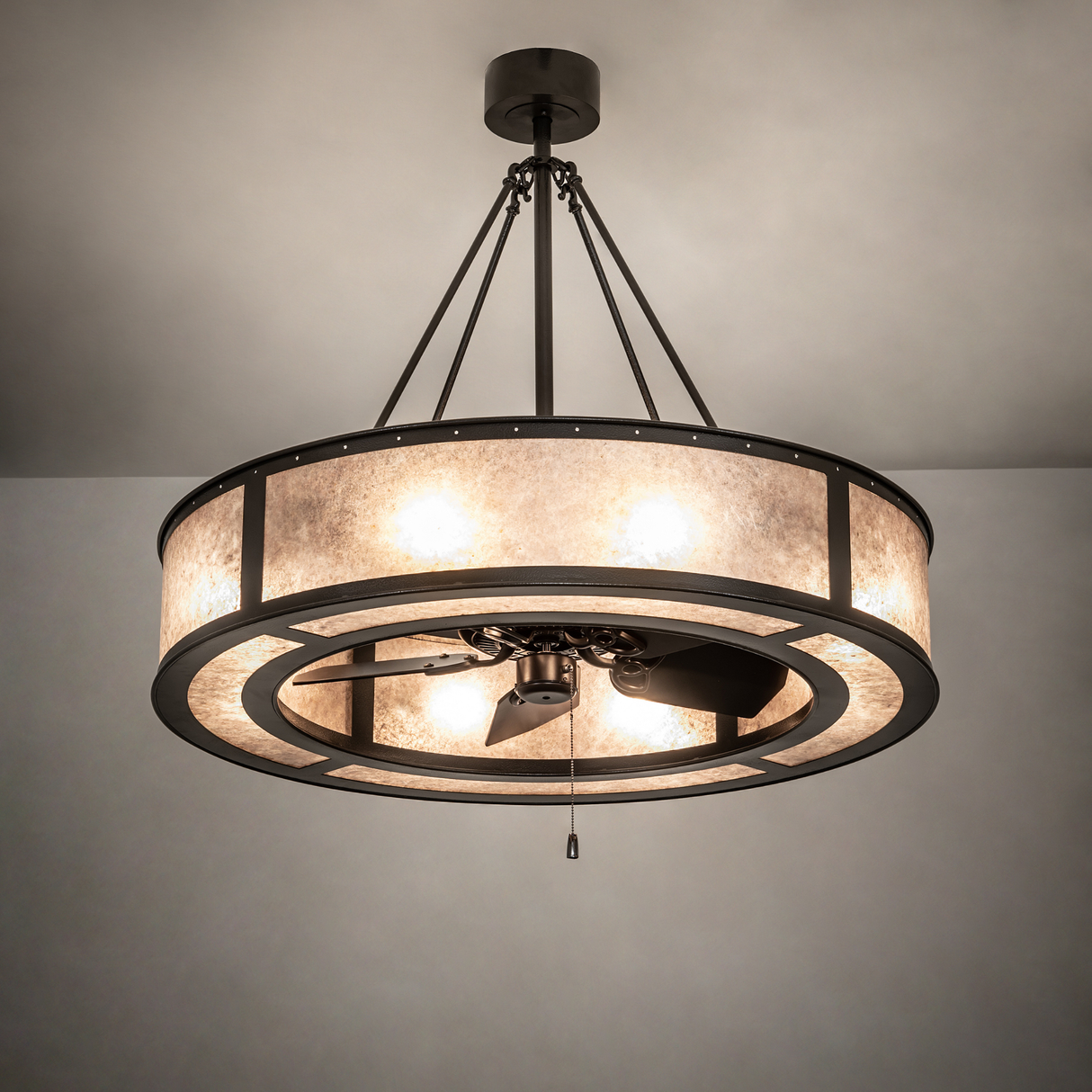 Smythe Craftsman Chandel-Air softly glowing in dark room lit view with subtle bronze sheen.