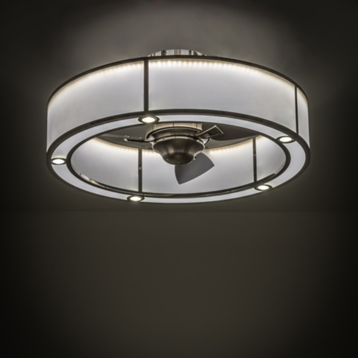 Ambient lit view of stainless chandel-air illuminating a dark room.