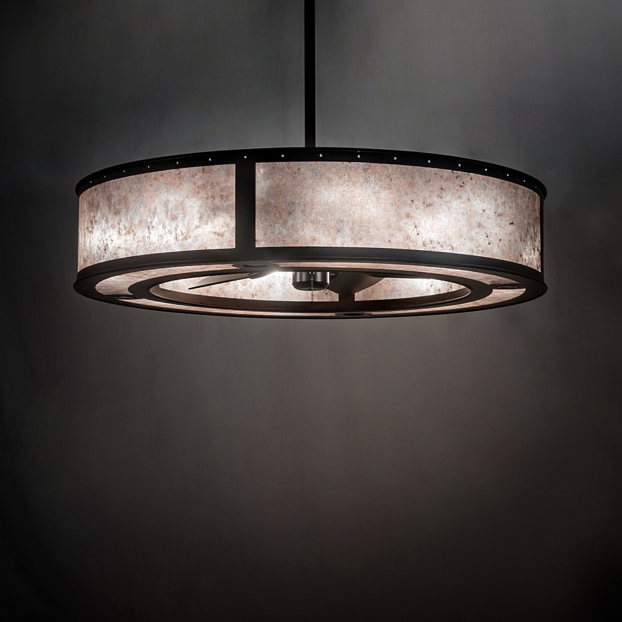 Smythe Craftsman chandelier fan casting soft light in elegant dark wall setting.