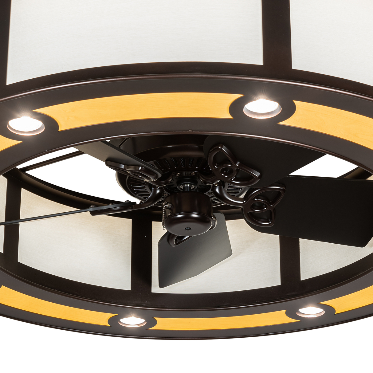 Close-up of fan blades and warm LED downlights under maplewood trim.