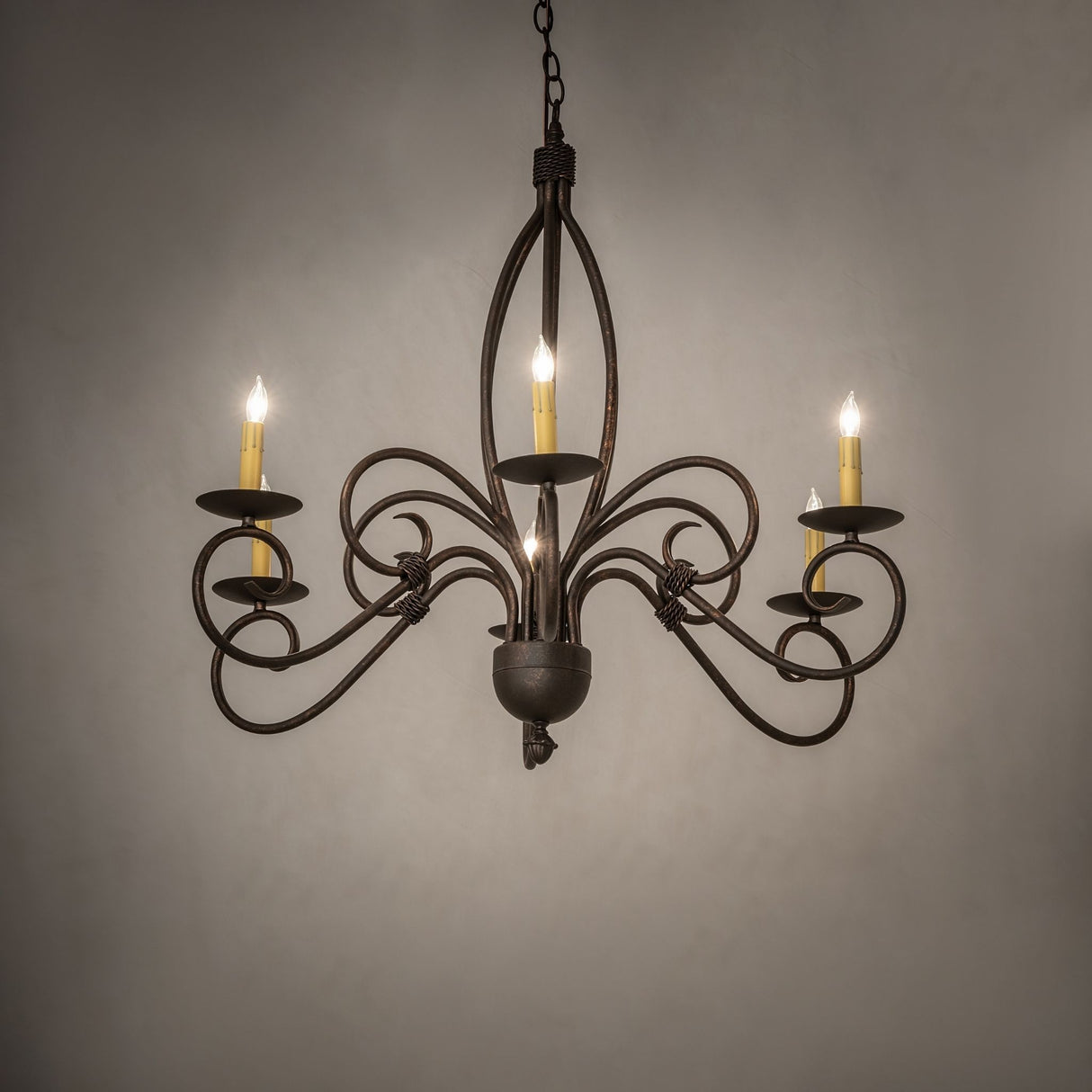 Squire six light chandelier shown in ambient room setting.