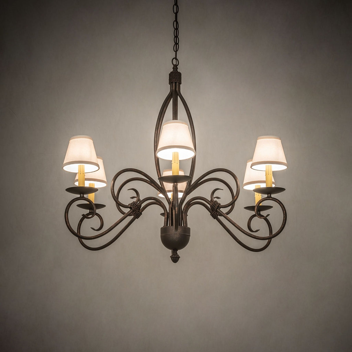 Ambient room lighting from Squire chandelier with warm glow.