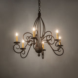 Ambient view of 6-light chandelier glowing in room setting, gilded tobacco finish.