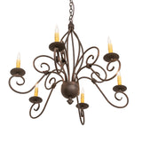 Lower angle view of chandelier showing scrolled iron arms and candle-style lights.