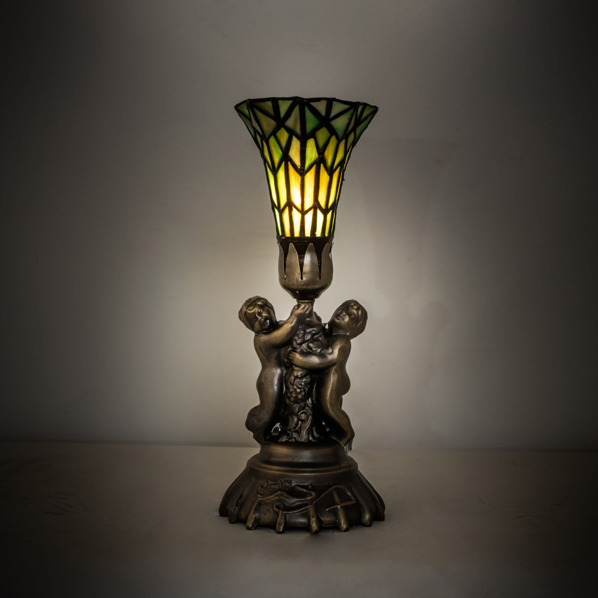 Illuminated view of the 13" High Stained Glass Pond Lily Twin Cherub Accent Lamp.