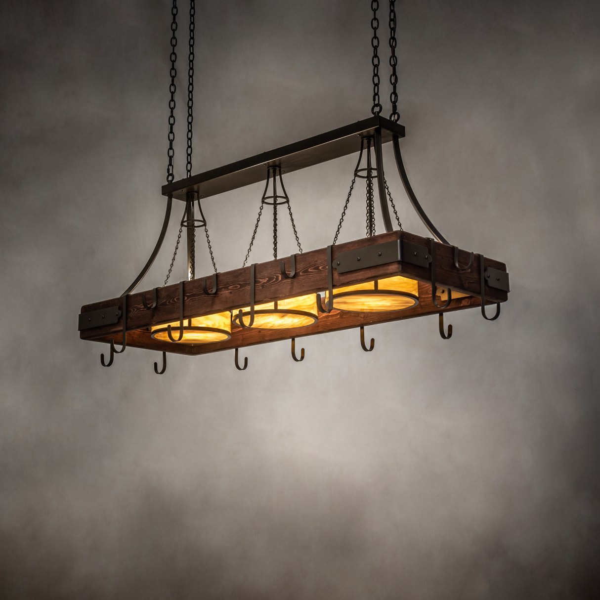 Steamboat 3 light pot rack chandelier illuminated in room setting.