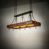 Steamboat 3-light pot rack chandelier glowing warmly in room setting.