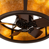 Close-up of fan blades beneath illuminated amber mica panels.