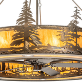 Close-up of metal pine tree design and amber mica illumination.