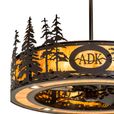 Close-up lit view of ADK logo and intricate pine tree silhouette details.