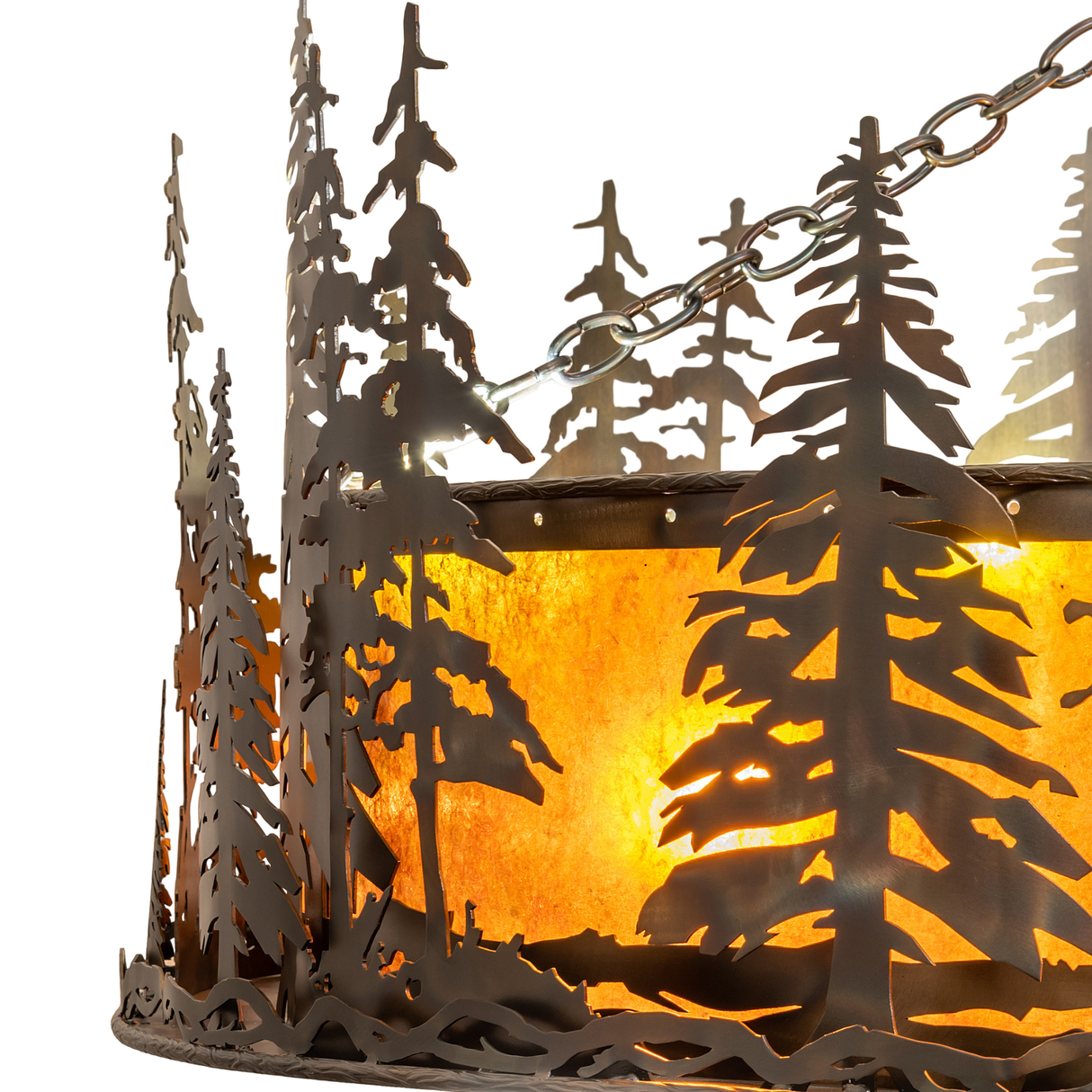 Closeup of handcrafted pine tree silhouettes and mica panel texture glowing warmly.