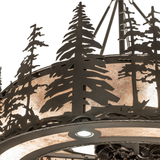 Close-up of handcrafted pine tree silhouettes on mica diffuser surface.