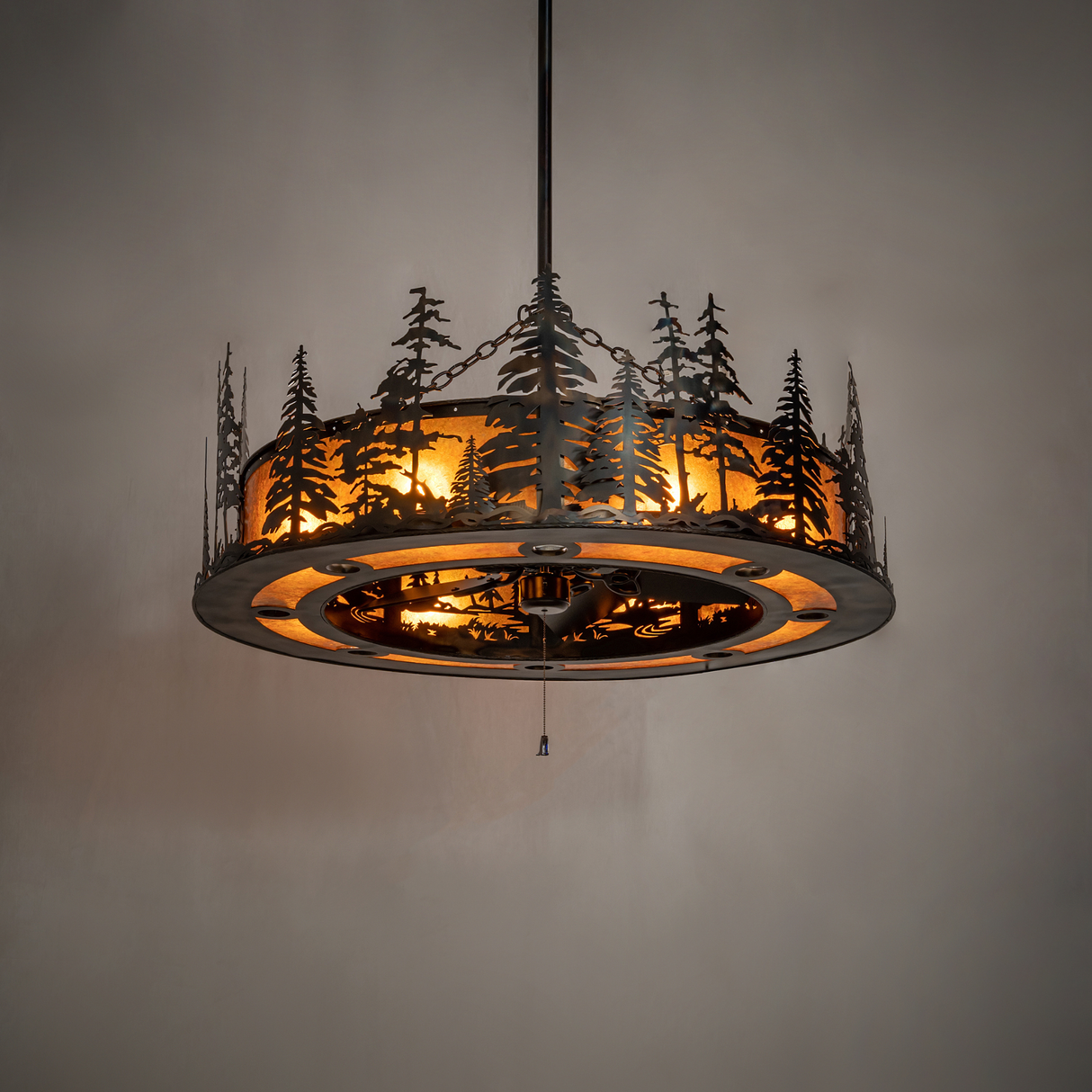 Tall Pines Chandel-Air fully lit in dark room showing warm amber glow and pine silhouettes.