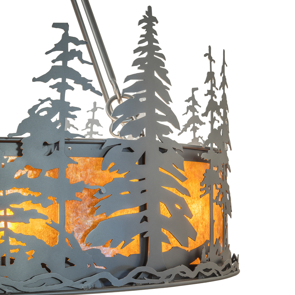 Close-up of pine tree cutout metalwork with illuminated amber mica.