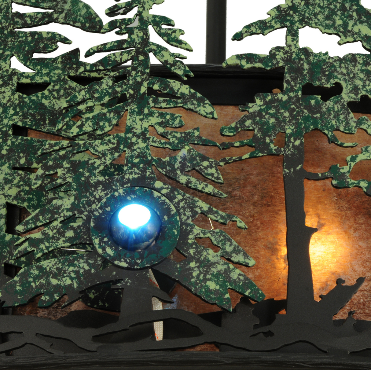 Detailed view of fan blades and woodland scene on glowing mica diffuser.