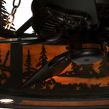 Closeup of fan motor and blades against glowing forest pattern.