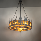 Illuminated Tall Pines chandelier fan glowing with amber mica light.