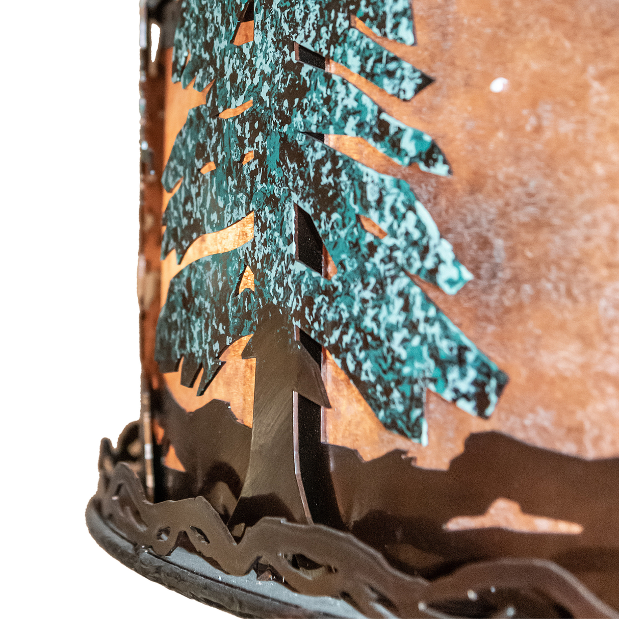 Close-up showing snow-dusted green pine trees on bronze-finished band.