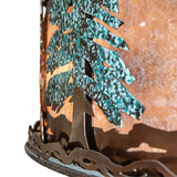 Close-up showing snow-dusted green pine trees on bronze-finished band.