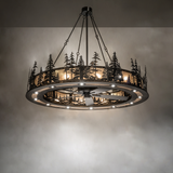 Illuminated chandelier fan casting warm forest-themed glow.