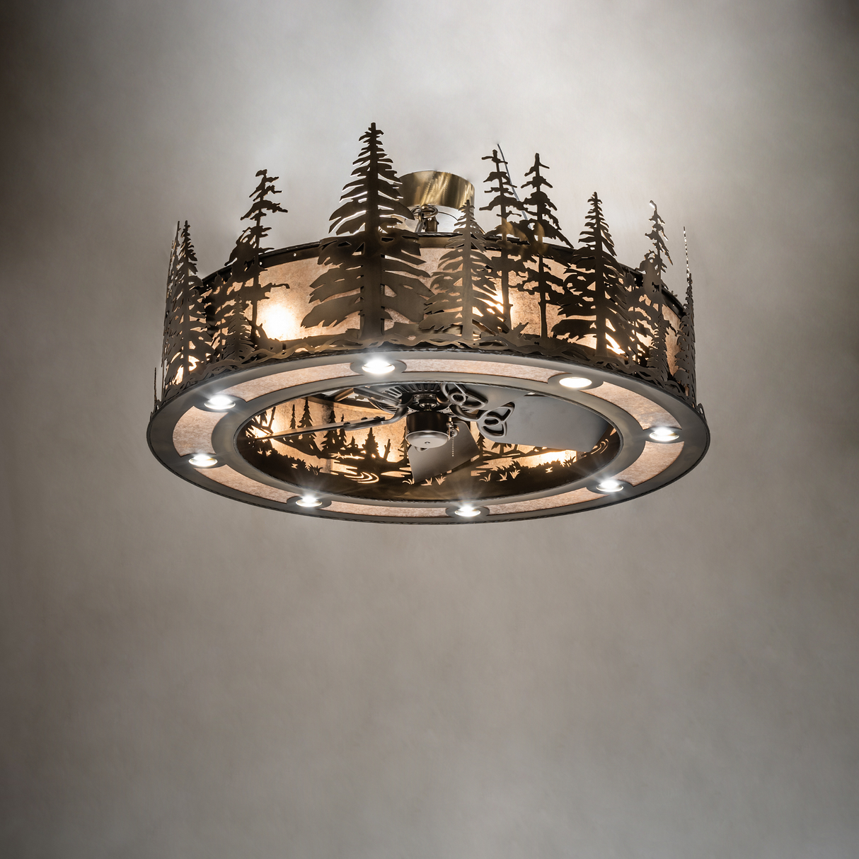 Tall Pines Chandel-Air softly illuminating a room with rustic pine forest design.