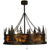 Side lit view showing layered pine trees and amber illumination.