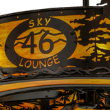 Closeup of Sky Lounge 46 logo illuminated through amber Idalight shade.