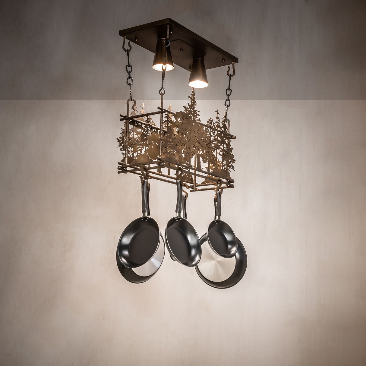 Lit Tall Pines pot rack chandelier in rustic kitchen setting.