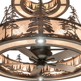 Close-up of Tall Pines chandelier showing intricate pine details and fan.
