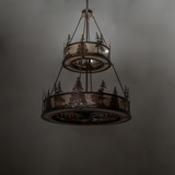 Dimly lit Tall Pines chandelier showing forest silhouette details.