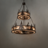 Warm glowing Tall Pines chandelier fan with layered pine tree pattern.