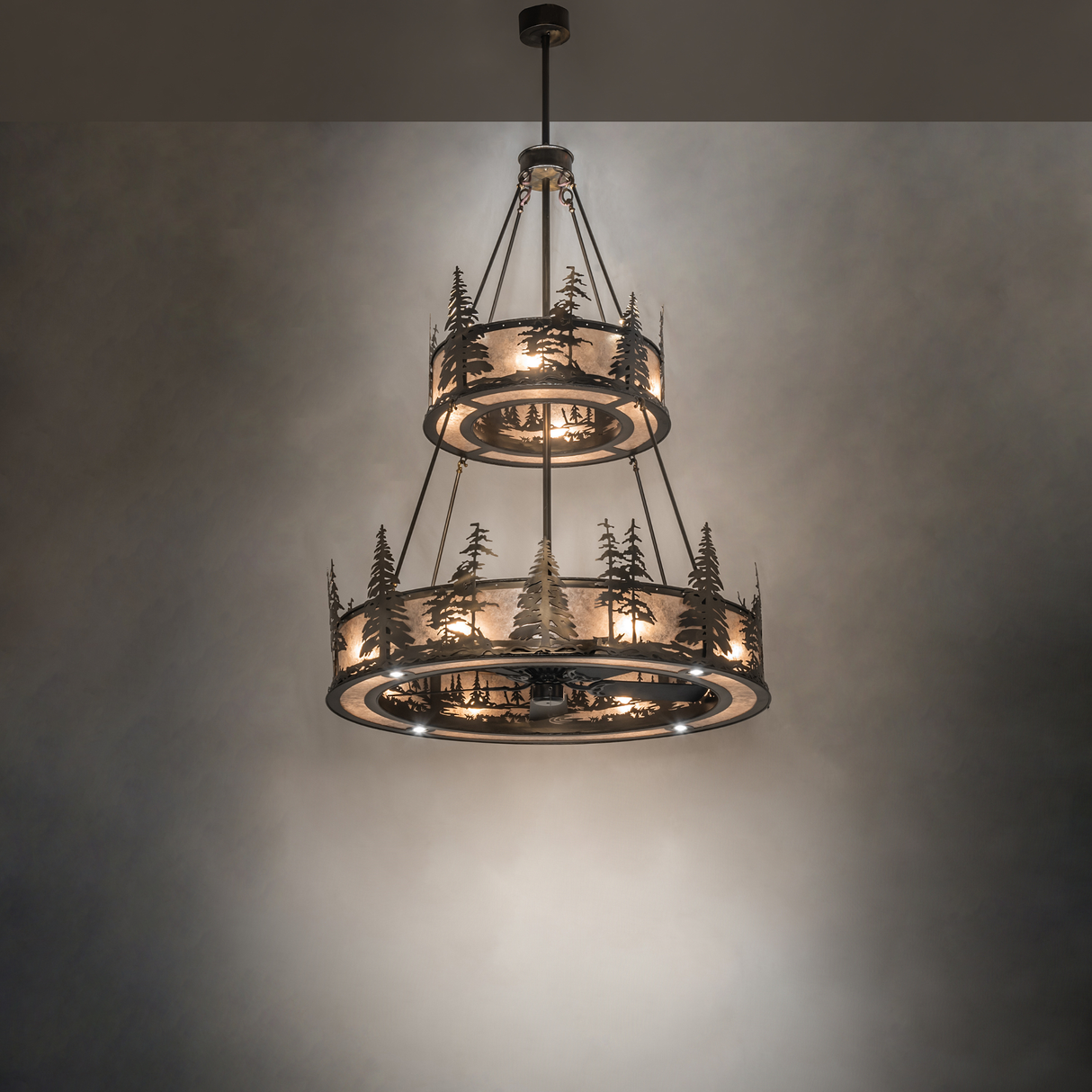 Lit chandelier fan creating soft woodland glow in room ambiance.