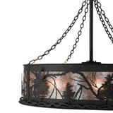 Close-up highlighting metal Tamarack tree cutouts and mica backdrop.