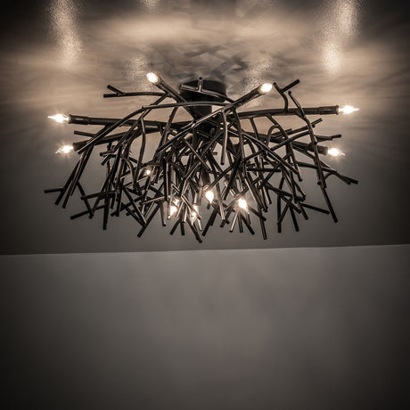 Ambient view of Thicket chandelier casting warm light with artistic branch-style metal design.