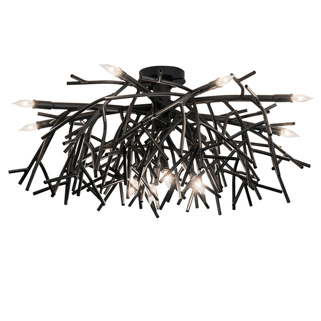 Lit view of Thicket chandelier showcasing branch-inspired black metal arms with glowing bulbs.