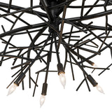 Close-up of chandelier metal branches with blackwash finish and handcrafted welded details.