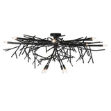 Side angle view of chandelier with layered branch arms and sculptural metal design.