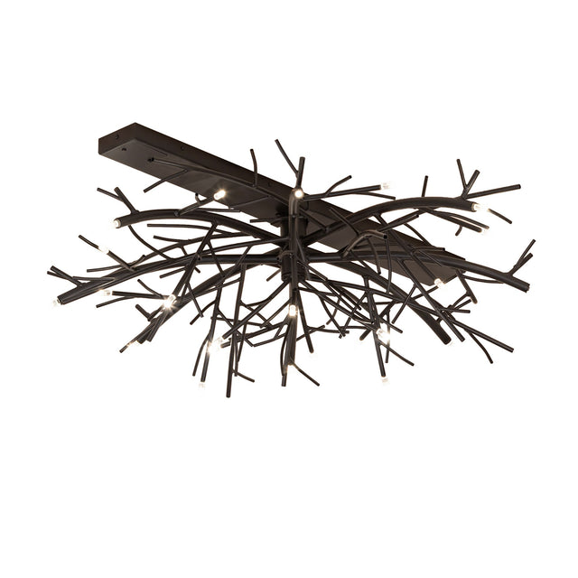 Lit view of chandelier, featuring branch-inspired metal arms in blackwash finish.