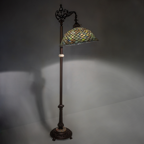 Tiffany Fishscale floor lamp glowing softly in ambient light.