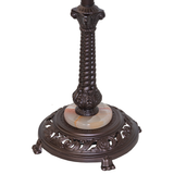 Detailed view of mahogany bronze base with lionfoot accents.