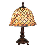 lit view of tiffany fishscale mini lamp casting a warm and inviting glow.
