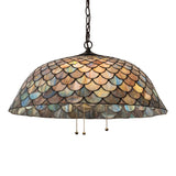 Illuminated Tiffany Fishscale pendant with vibrant honey-dripped emerald and amber hues.