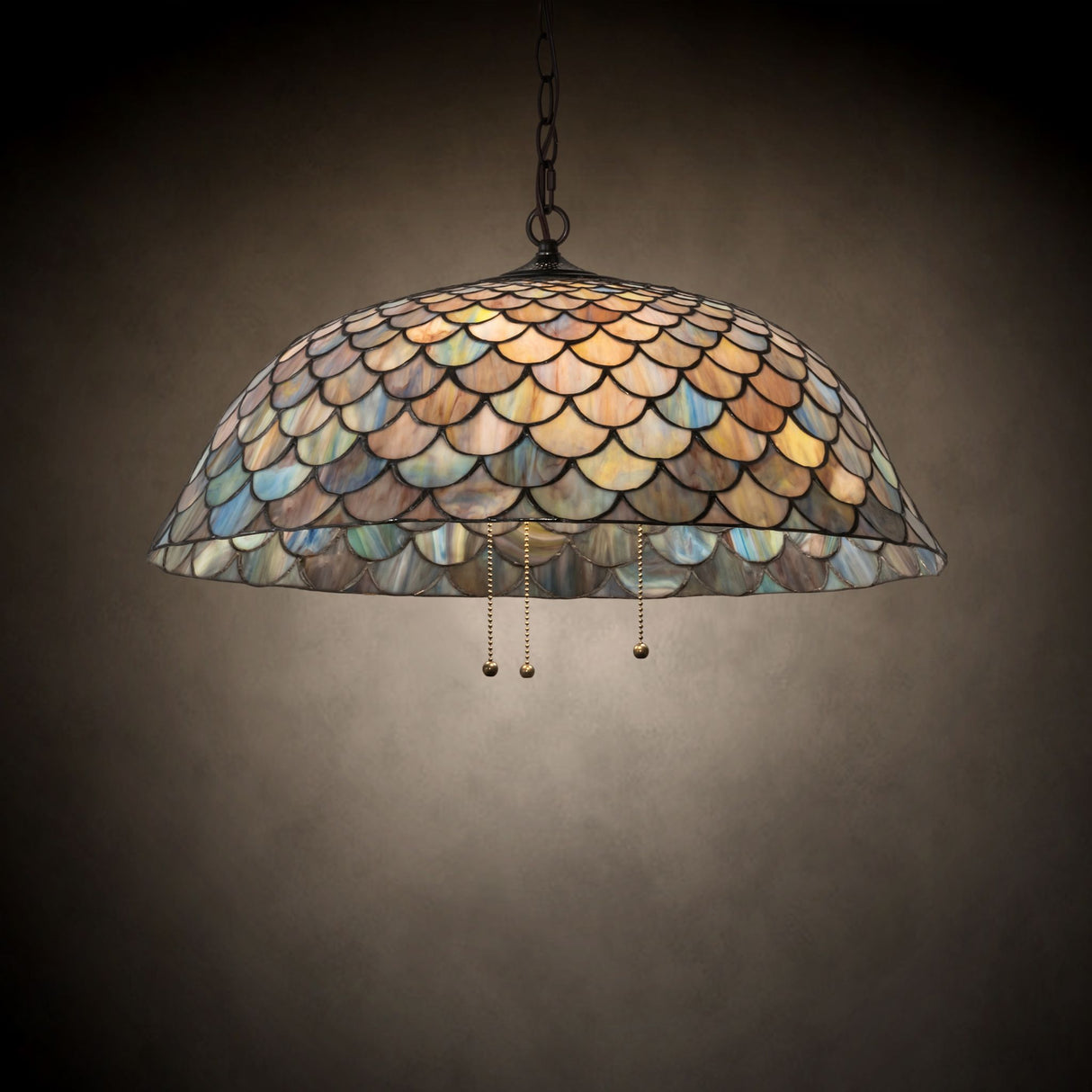 Tiffany Fishscale pendant in a room view with warm, glowing tones.