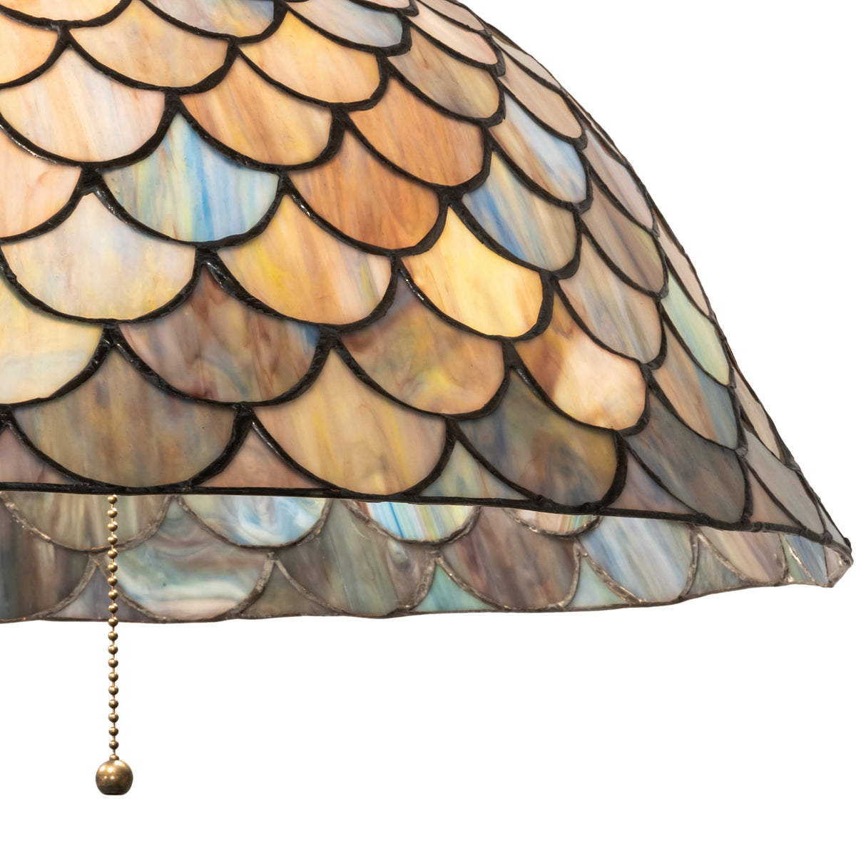 Side detail of Tiffany Fishscale pendant showing rich honey and emerald hues.
