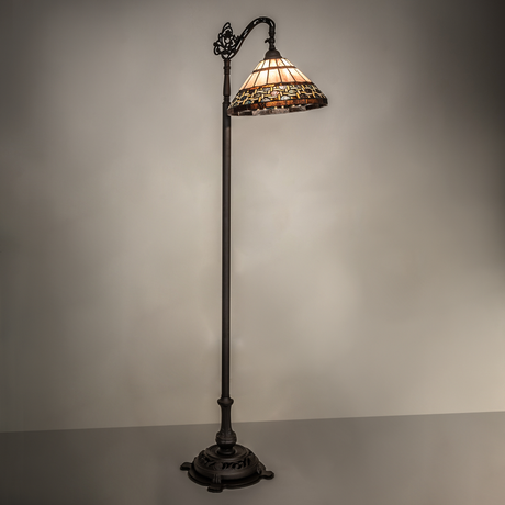 Tiffany Ilona bridge arm floor lamp glowing in warm ambient light.