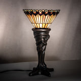 Tiffany Jeweled Peacock Mini Lamp illuminated, showcasing its colorful glass shade in a dark room.