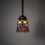 Illuminated Tiffany peacock feather mini pendant hanging in a dim setting.