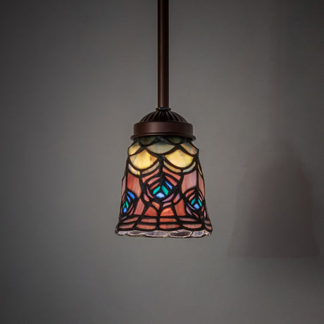 Illuminated Tiffany peacock feather mini pendant hanging in a dim setting.