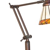 Close-up of adjustable bronze lamp arm and joint detail.